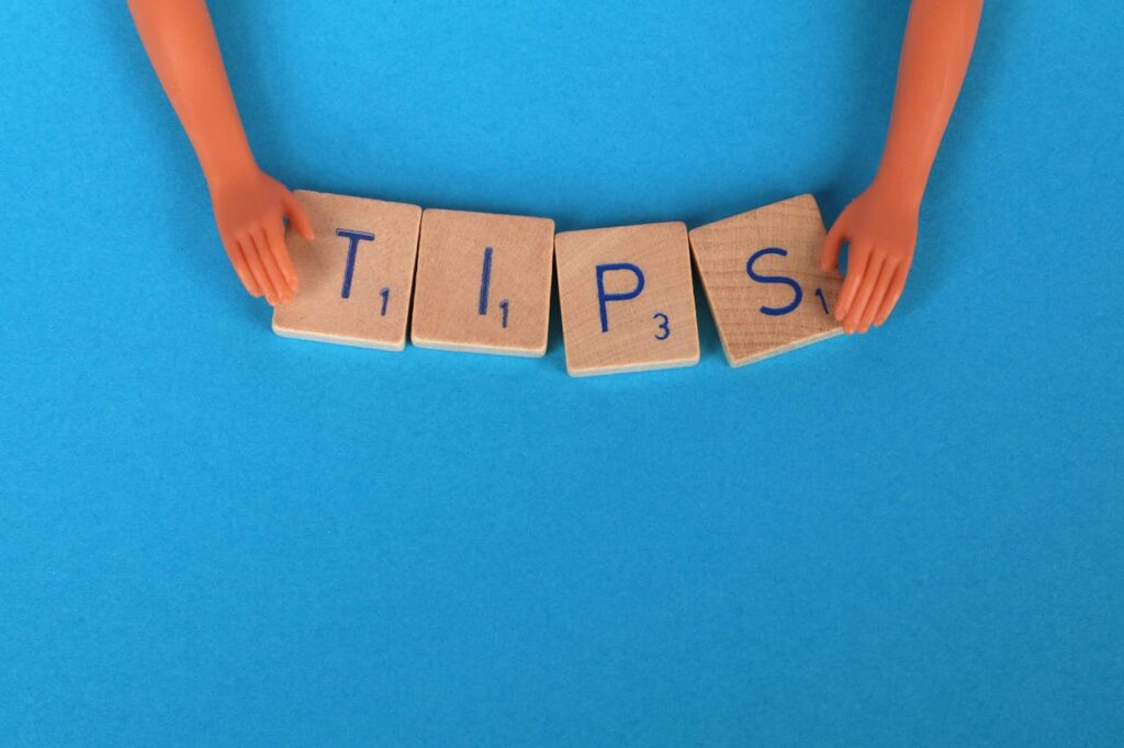 Close-Up Shot of Scrabble Tiles on a Blue Surface